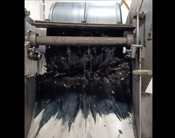 Image of Eriez laboratory drum separator collecting magnetic concentrate while operating at a magnetic intensity of approximately 1,000 Gauss, Low Intensity Magnetic Separation (LIMS) process.
